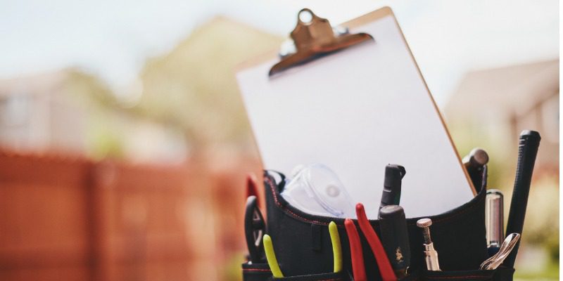 A clipboard with some tools in it